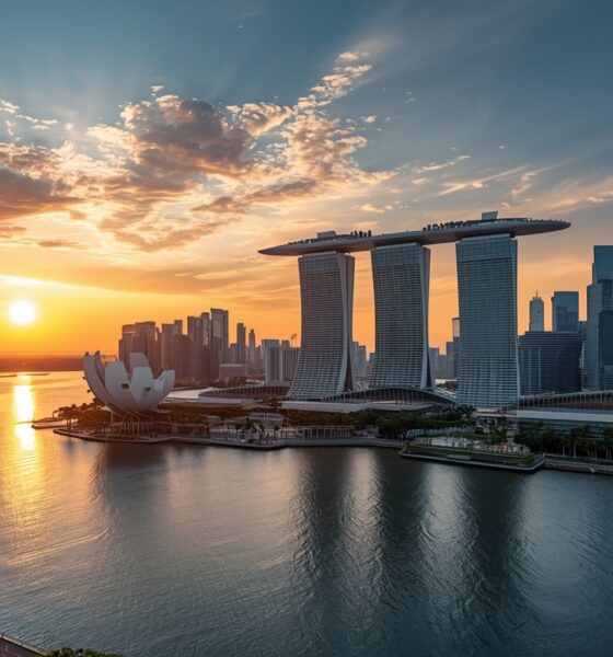 Ultra-luxury Singapore skyline at sunset, Marina Bay waterfront, futuristic high-rise condominiums with sky gardens and infinity pools, warm golden hour lighting, smart glass towers, lush greenery integrated into architecture, reflections on calm water, cinematic wide-angle view, hyper-realistic, 8K resolution, ultra-detailed, professional architectural photography, vibrant yet natural colors, sharp focus, no people, high dynamic range, magazine cover quality